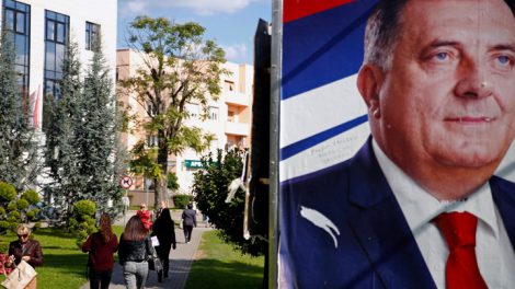 People pass by Milorad Dodik's pre-election poster in Banja Luka